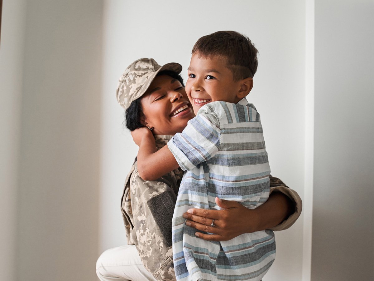 Military mom holding son
